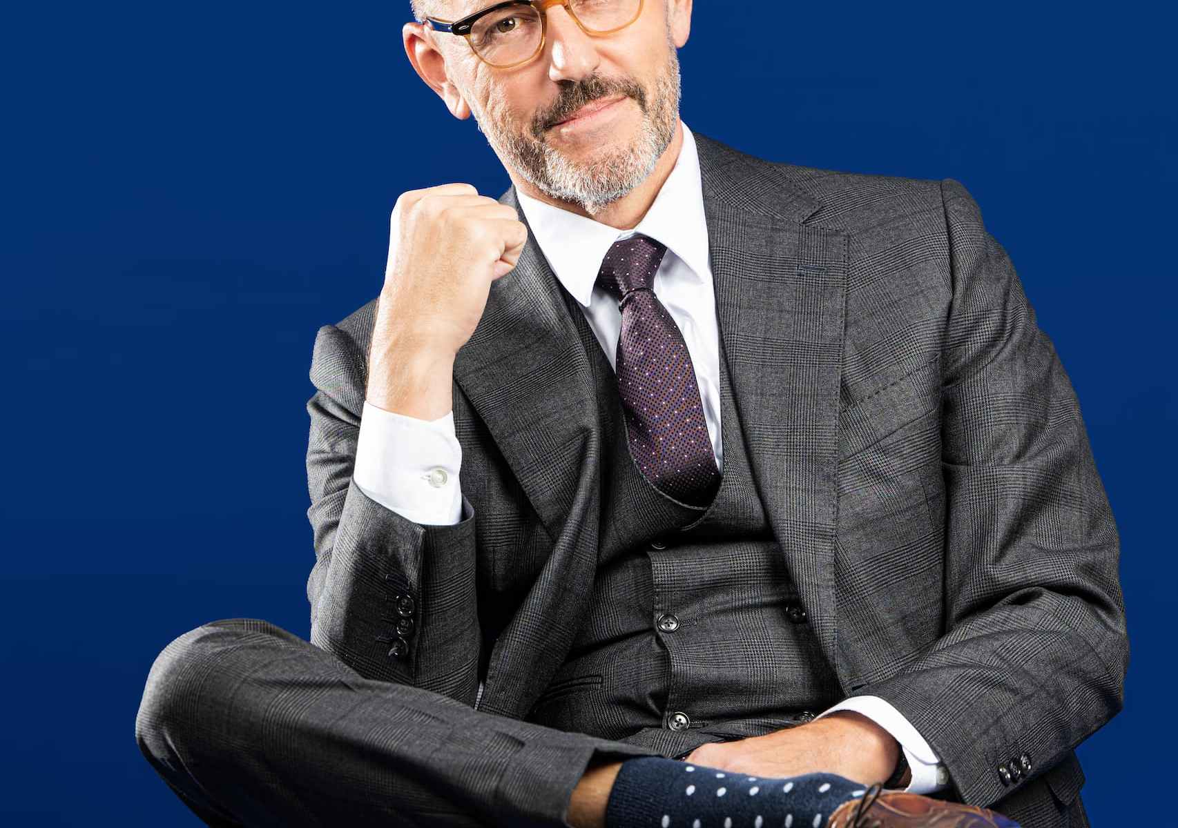 jozef opdeweegh in sitting in a black suit pumping his first